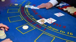 Boom Baccarat shoe display with dealer holding card